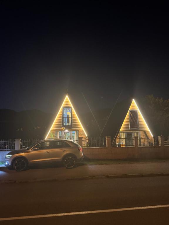 a car parked in front of a house at night at Tara lux in Mojkovac