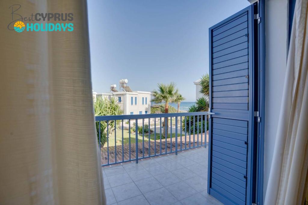 a door to a balcony with a view of the ocean at Ammos Villa 20 Side Seaview in Larnaka