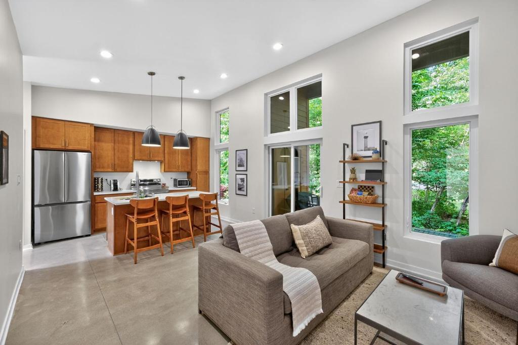 a living room with a couch and a kitchen at 500 House - Unit A townhouse in Thiensville