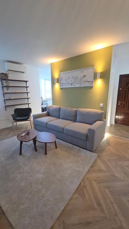 a living room with a couch and a table at Ultracentral Mangalia seaside exclusive in Mangalia