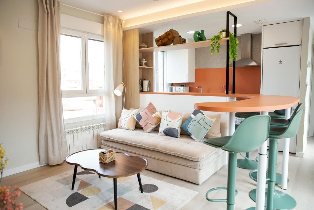 a living room with a couch and a table at Zabella Ossau - Nuevo ático a estrenar en el tubo in Zaragoza