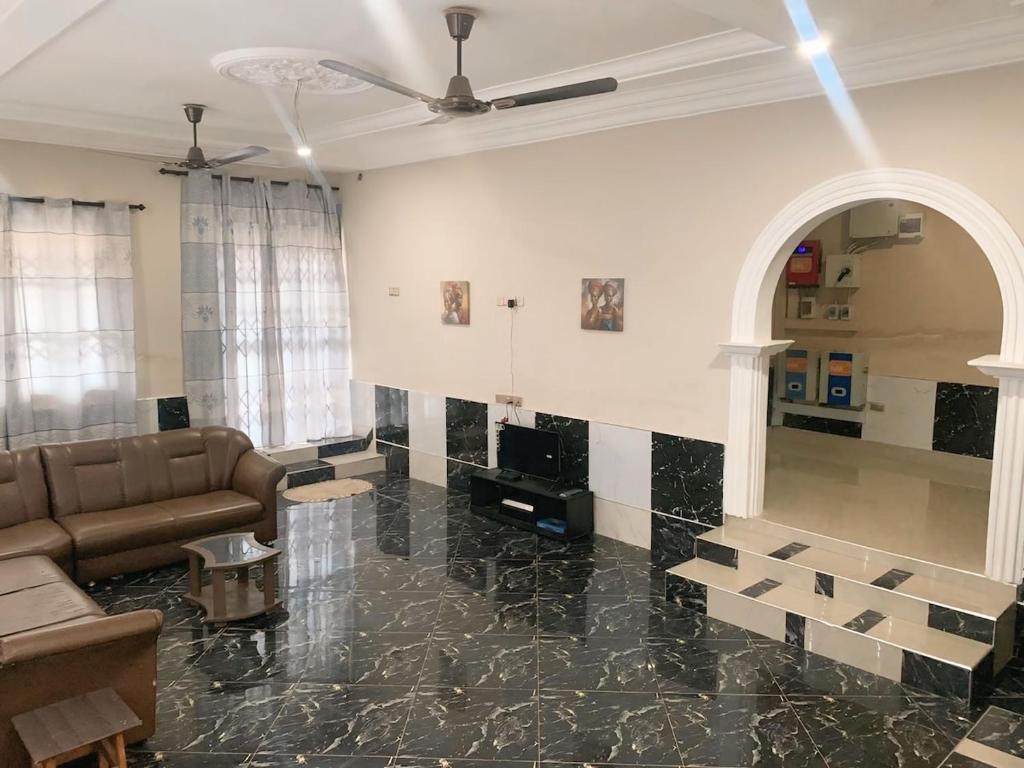 a living room with a couch and a fireplace at StayComidad in Dawhwenya