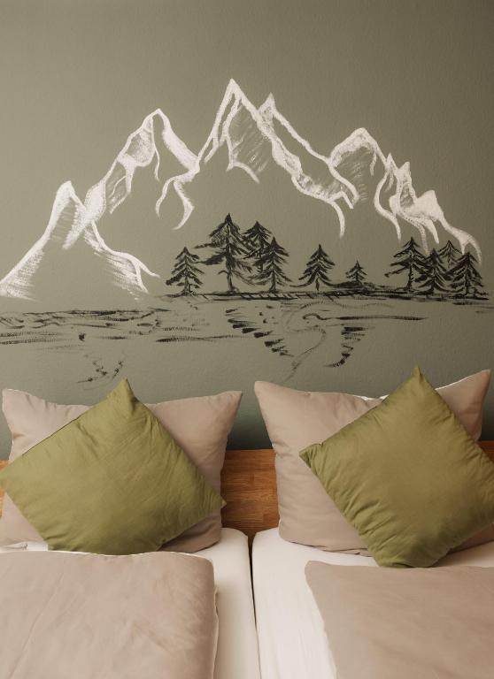 a bedroom with a mountain mural on the wall at Grünten-Blick Apartment in Sonthofen