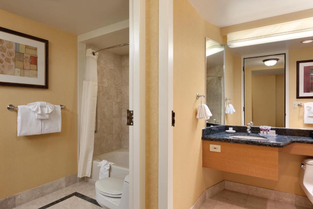 a bathroom with a sink and a toilet and a tub at Harrah's Lake Tahoe Hotel & Casino in Stateline