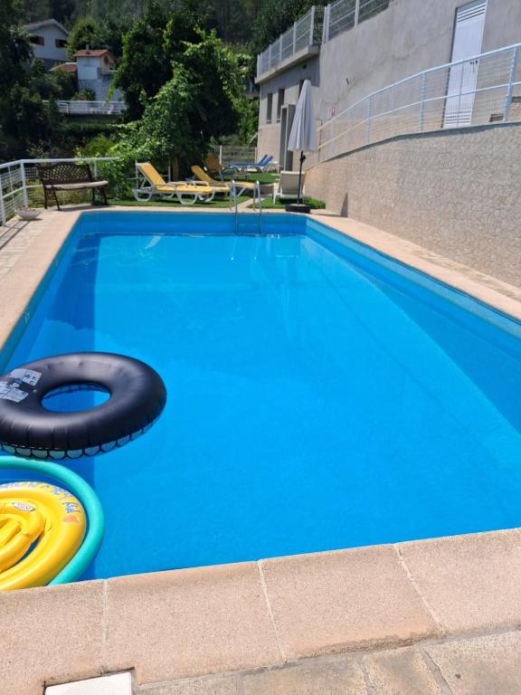 a large blue swimming pool with a yellow frisbee at Casa Marciana in Geres