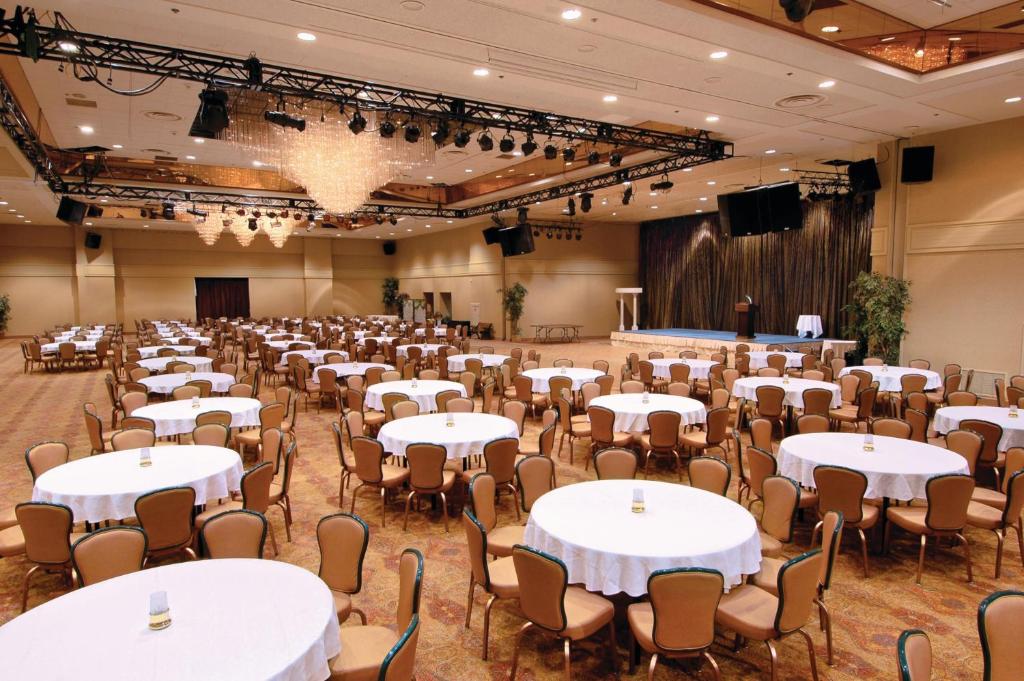 a banquet hall with tables and chairs and a stage at Harrah's Lake Tahoe Hotel & Casino in Stateline