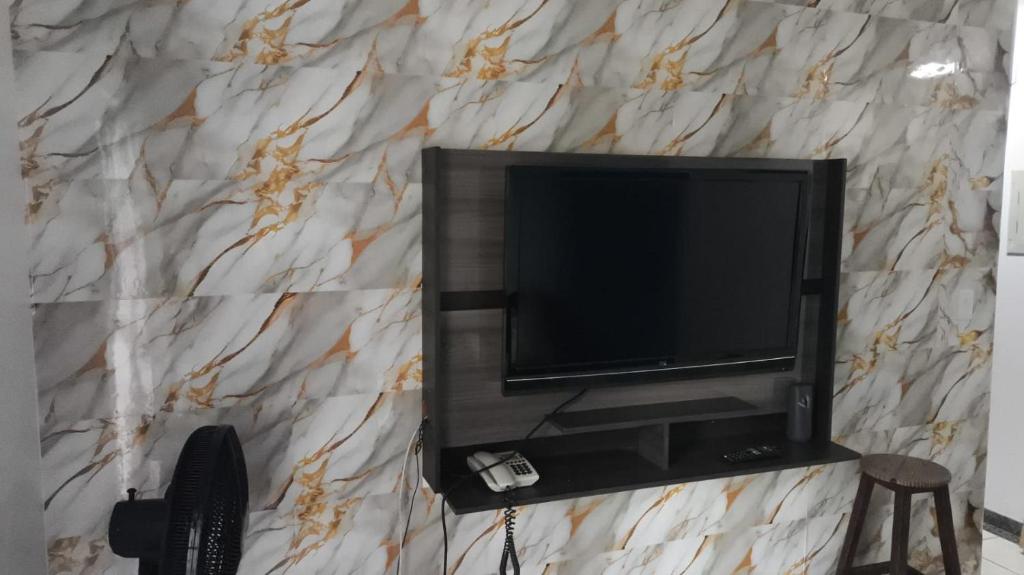 a flat screen tv on a marble wall at Rio Quente Thermas Paradise in Rio Quente