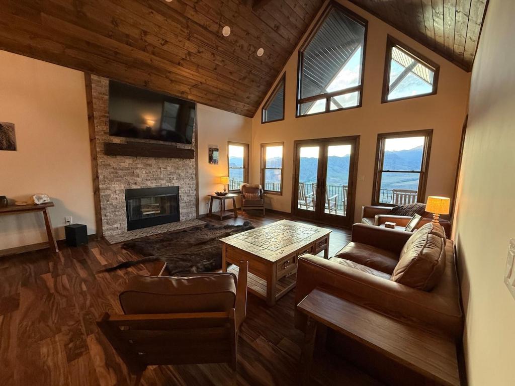 a living room with a couch and a fireplace at Cody WY Yellowstone Luxury Mountain Retreat 