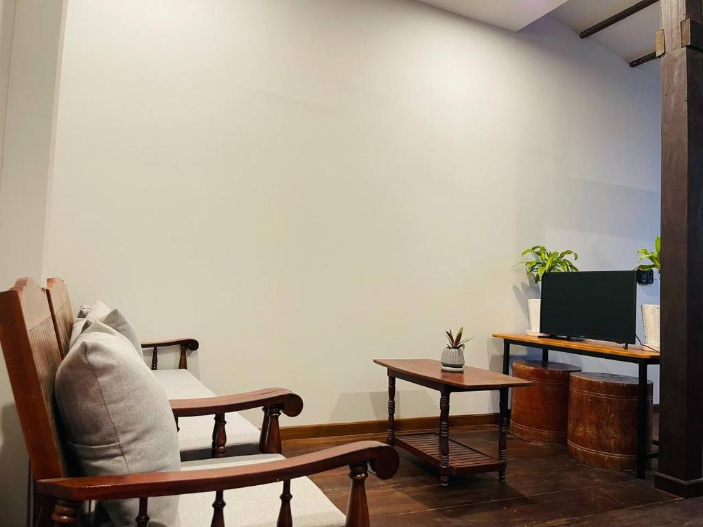 a living room with a chair and a table at Roya Khmer Homestay in Siem Reap