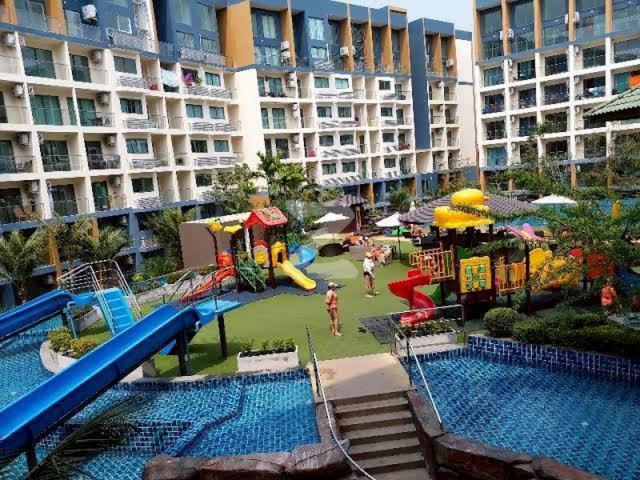 an outdoor playground with a slide and a water park at Laguna Beach Resort 2 in Ban Chek