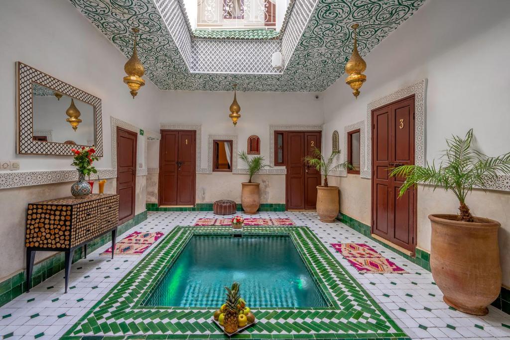 a swimming pool in the middle of a room at Riad Jowara in Marrakech