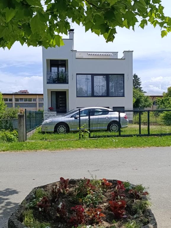 a car parked in front of a house at Apartman Una na dlanu, Novi Grad in Bosanski Novi