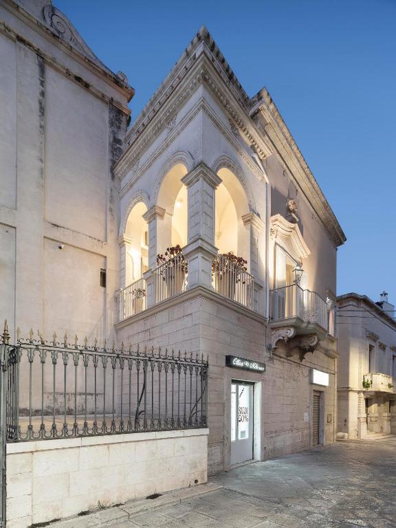 a building with a balcony on the side of it at Palazzo Alchimia in Fasano