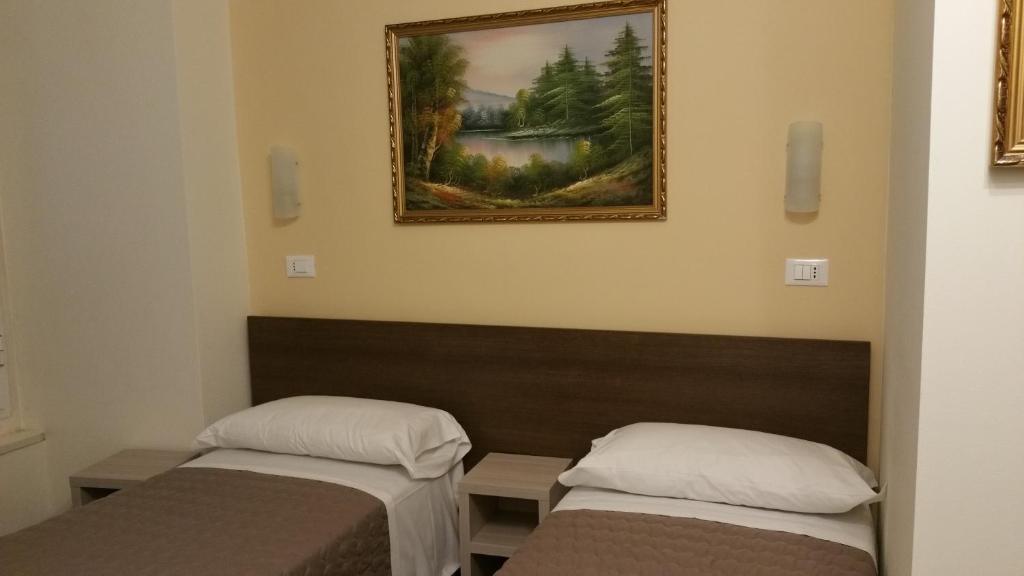 Postel nebo postele na pokoji v ubytování Hotel Tommaseo