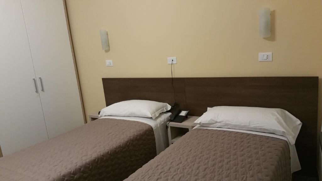 Postel nebo postele na pokoji v ubytování Hotel Tommaseo