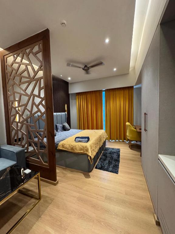 a bedroom with a bed and a large mirror at Galaxy blue sapphire plaza in Ghaziabad