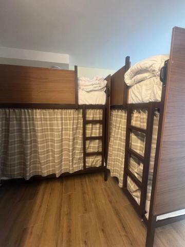 two bunk beds in a room with wooden floors at El Albuergo in Llanes