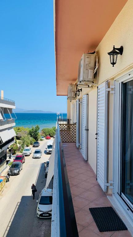 a balcony of a building with a view of a street at FK Apartment Sea View Balcony 60 m to the Beach Near Athens Airport and Rafina Port in Artemida
