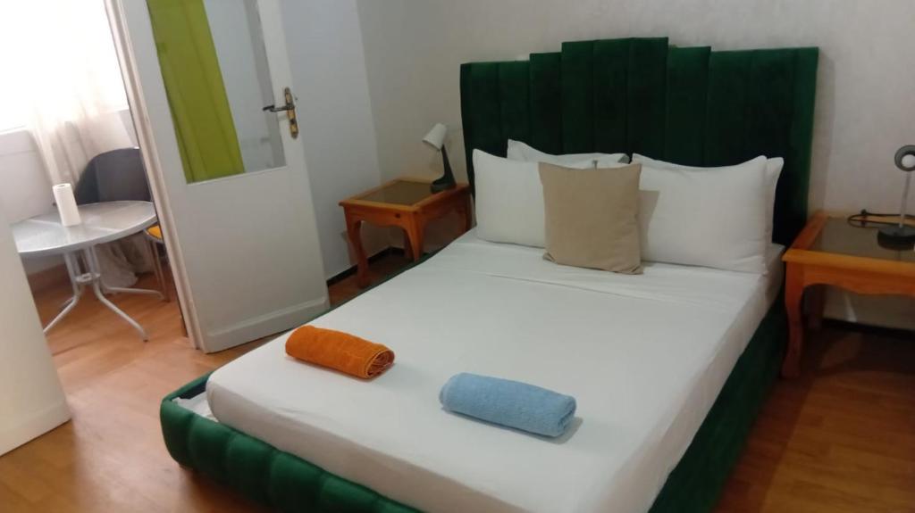 a bedroom with a large bed with two pillows on it at Joli chambre au coeur de tanger in Tangier