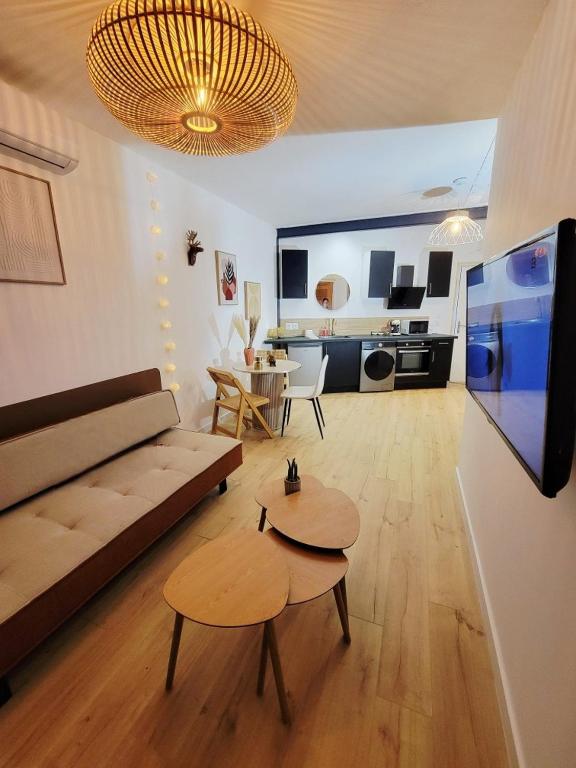 a living room with a couch and a table at Bohème Chic in Albi