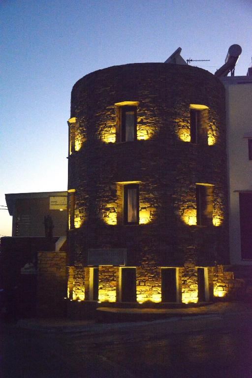 a building with lights on the side of it at Renthousetinos 2 in Tinos