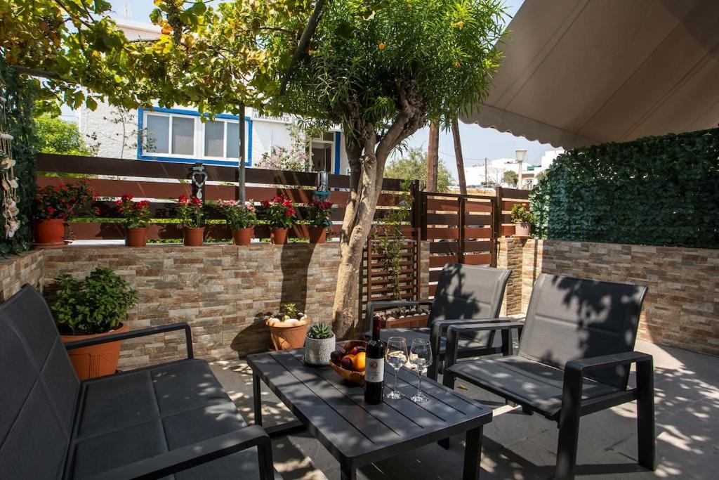 a patio with two chairs and a table with drinks on it at Gennadi Sea Escape in Gennadi