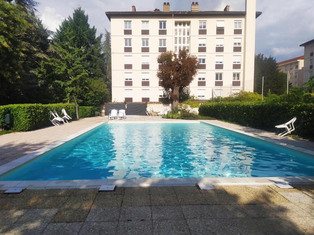 a swimming pool in front of a building at Cozy Studio Beaujolais - Porte de Lyon - Piscine&Tennis in Villefranche-sur-Saône