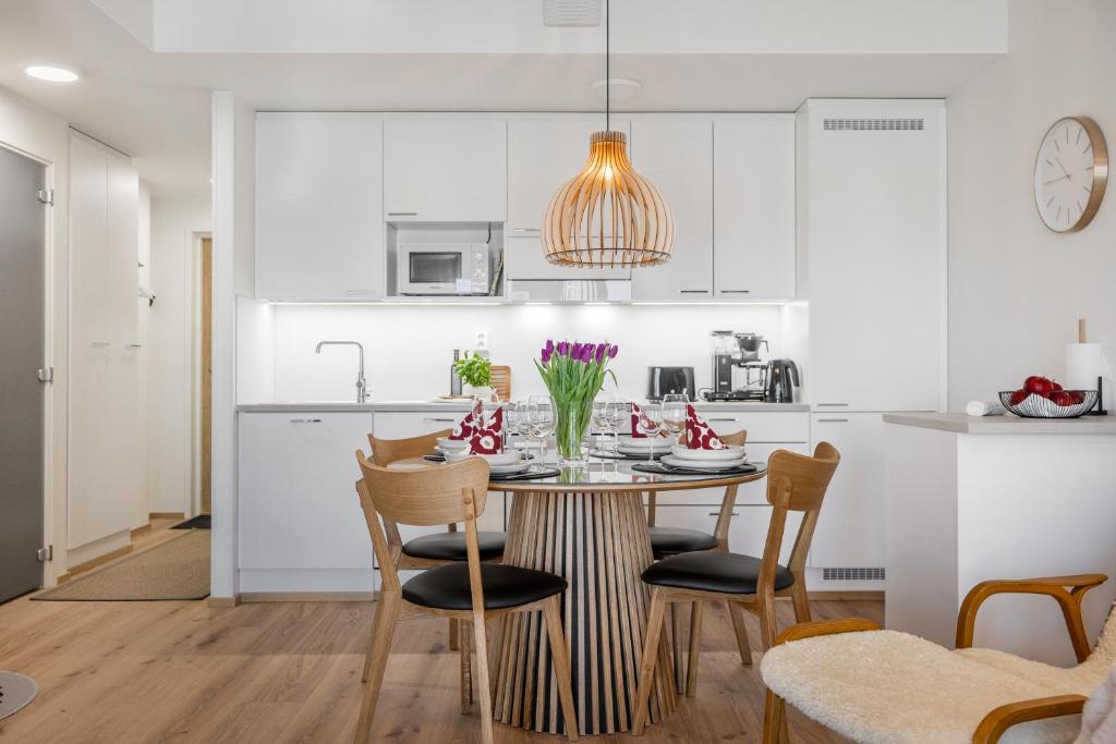 a kitchen and dining room with a table and chairs at Unique apartment - Best location with Sauna in Rovaniemi