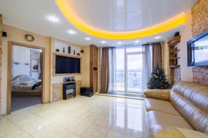 a large living room with a couch and a television at Апартаменты Делюкс с 1 спальней in Dnipro