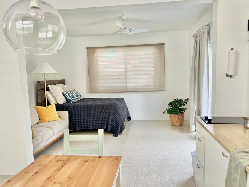 a living room with a bed and a couch at Cozy Studio near Beach & Airport in San Juan