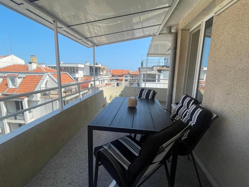 a table and chairs on a balcony with a view at KudevApartment1 in Nesebar