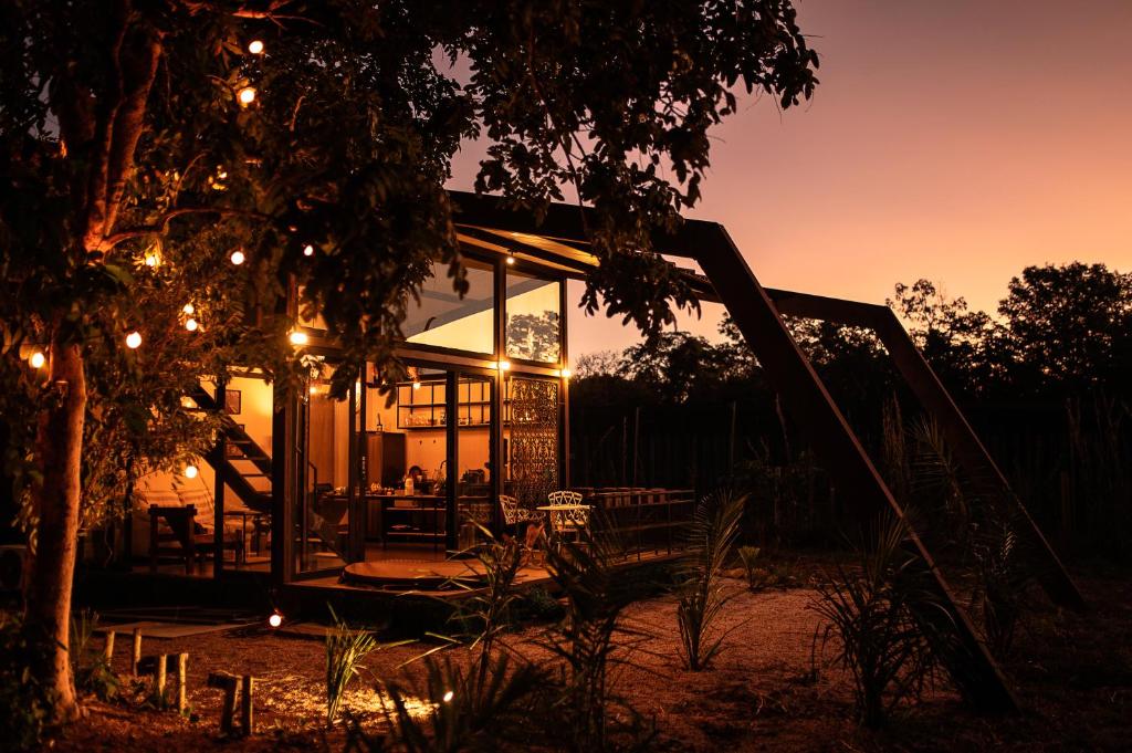 a house lit up at night with lights at Chale Baru - AC - rio e ofuro - Cavalcante in Teresina de Goias