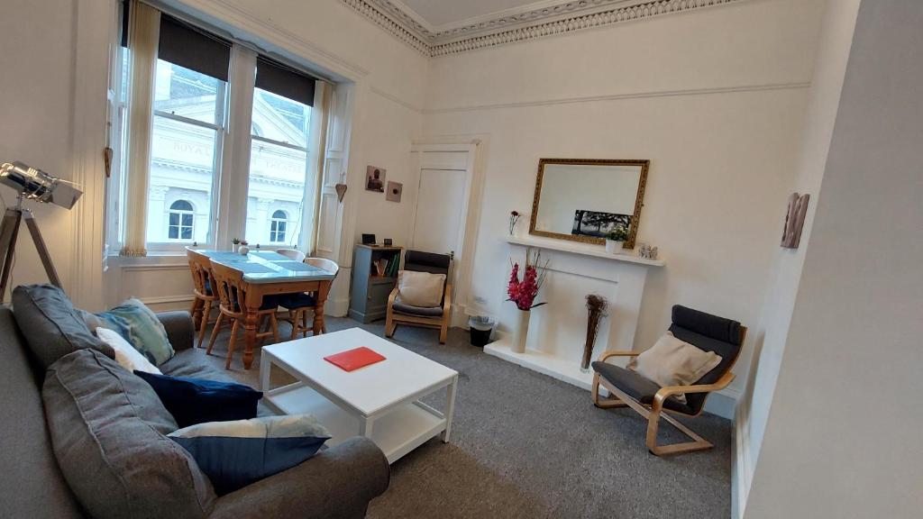 a living room with a couch and a table at Grindlay Street Residence, 2 Bedroom, 2 Bathroom apartment close to Castle in Edinburgh