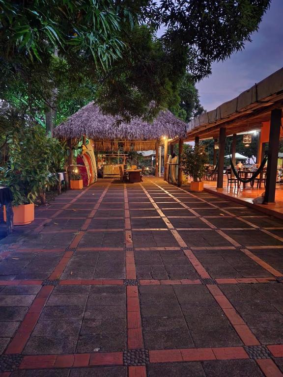 a walkway with a building with purple flowers on it at Atlakamani Surf in Chirilagua