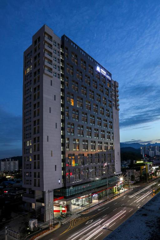 a tall building with a sign on top of it at Hotelaround Sokcho in Sokcho