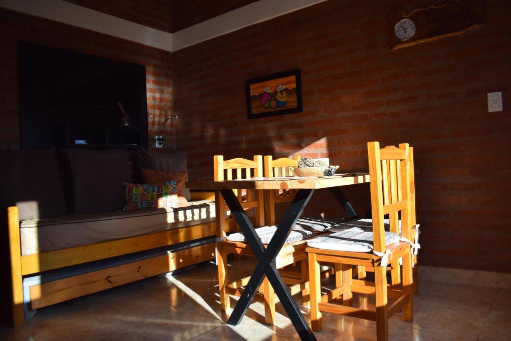 a table and chairs in a room with a bed at Apart-Maragato in Patagones
