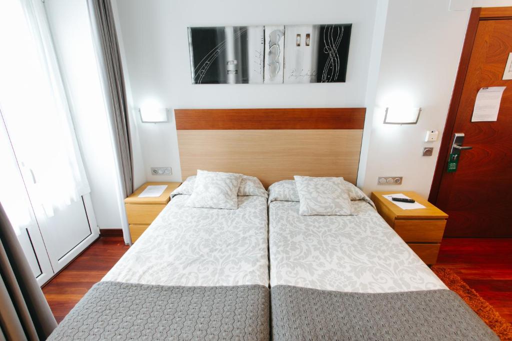 Posteľ alebo postele v izbe v ubytovaní Hostal San Sebastian Centro