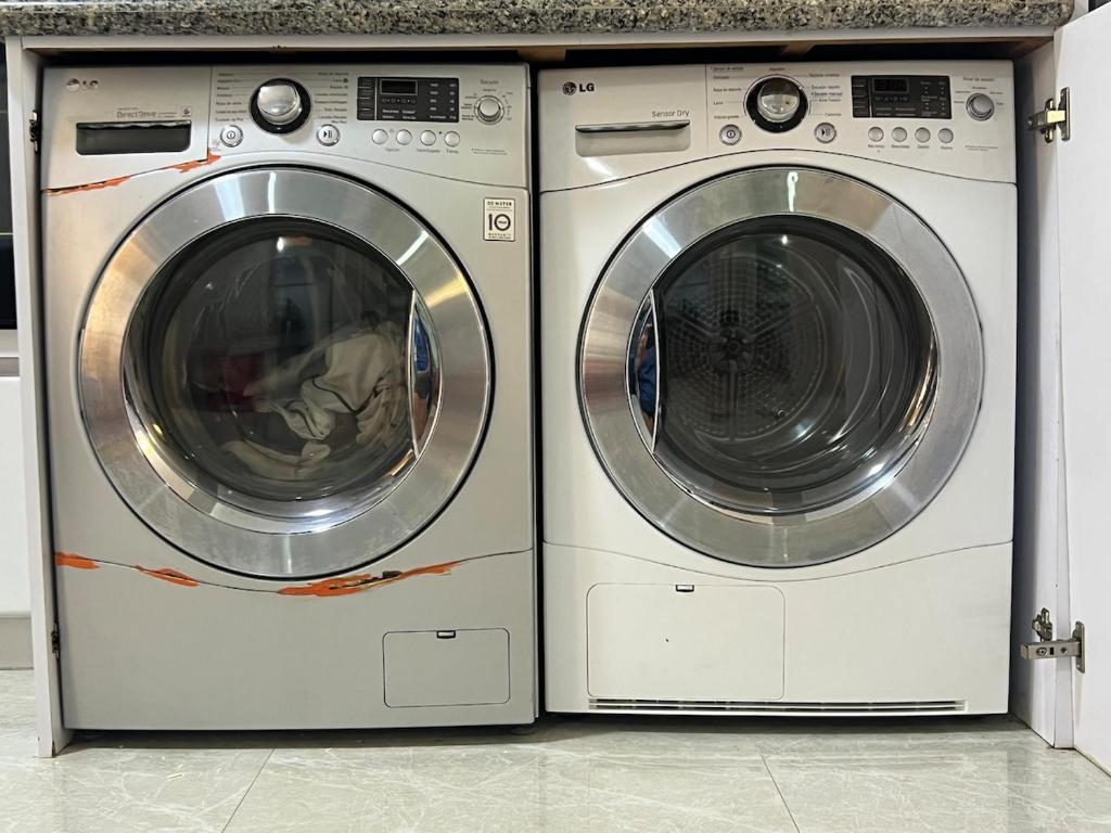 two washing machines are sitting next to each other at Premium Lecheria - Oceanfront, Pool & Relax in Morro de Barcelona