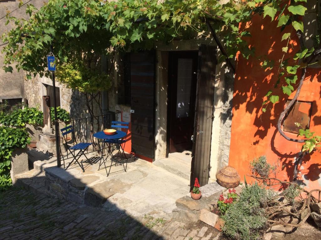 a patio with a table and chairs in front of a door at Casa Lucia in Motovun