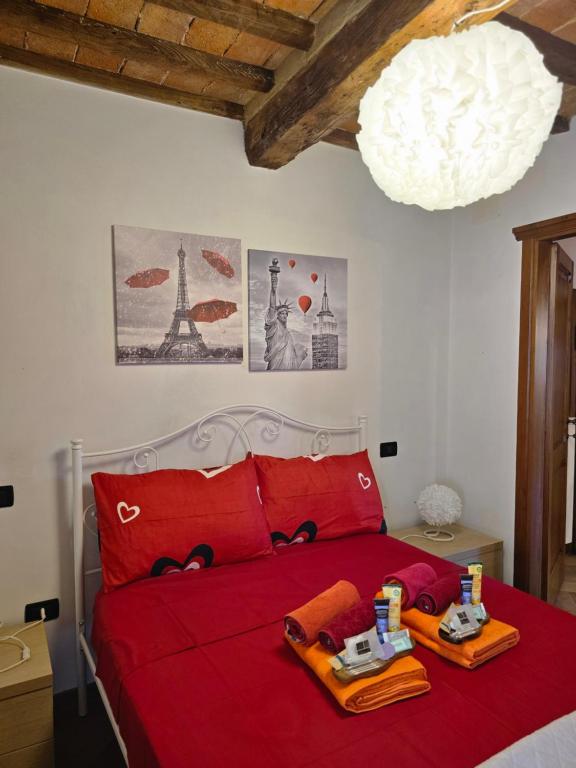 a bedroom with a red bed with two trays on it at Casa vacanze il Gelsomino in Abbadia San Salvatore