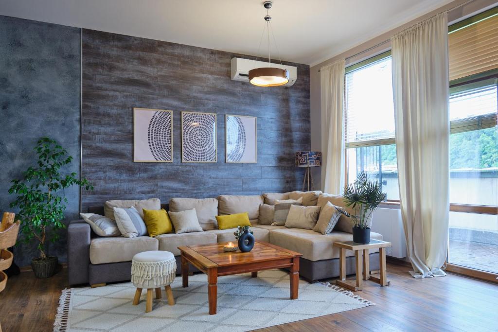 a living room with a couch and a table at Premier Luxury Apartment Center Gabrovo in Gabrovo