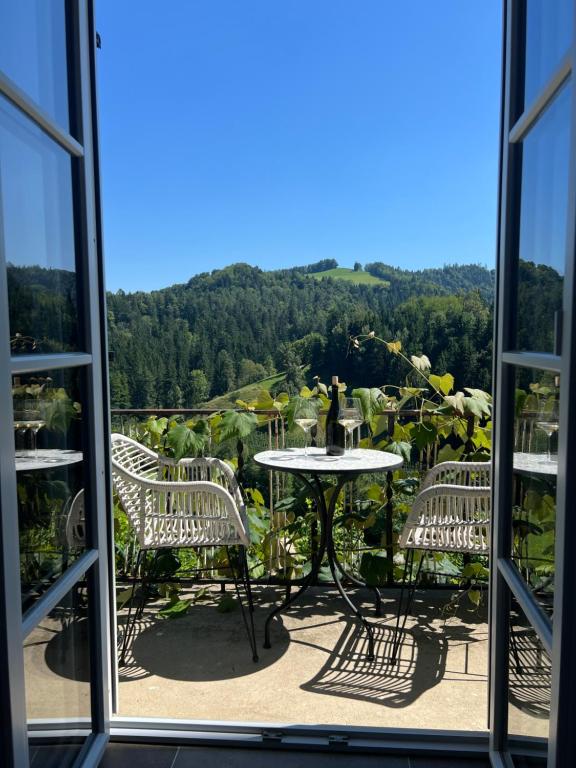 a view of a table and chairs from a window at Weingut Kleinmonte in Leutschach