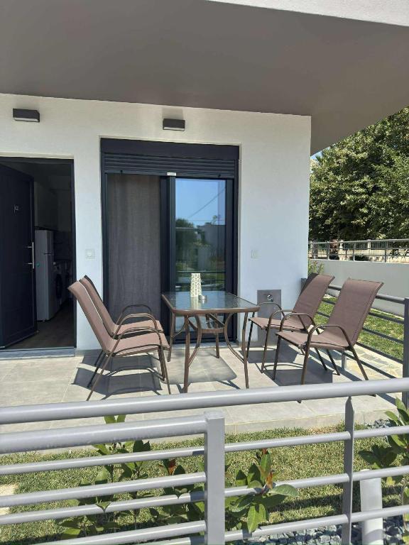 a patio with chairs and a table on a balcony at Xenia's Resorts in Ofrínion