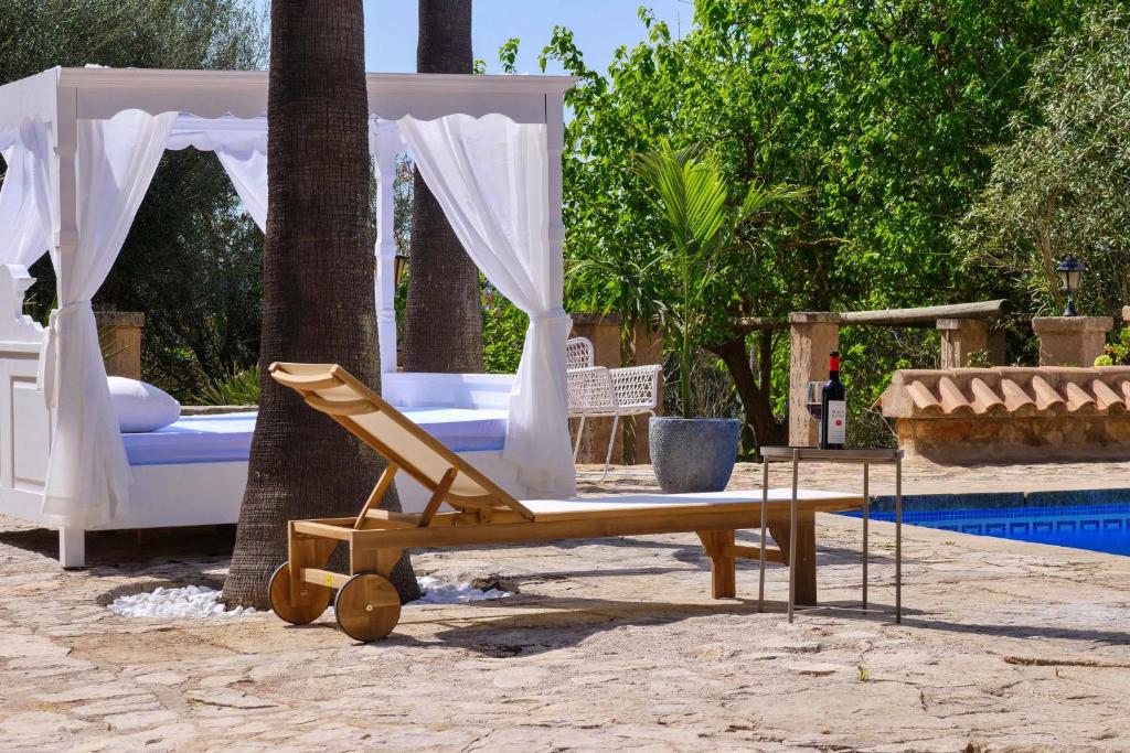 a bed and a swing next to a pool at FALCO , Apartment auf Finca Zenara, Terrasse, XXL-Pool, Küche, AC, WIFI, Yoga in Manacor