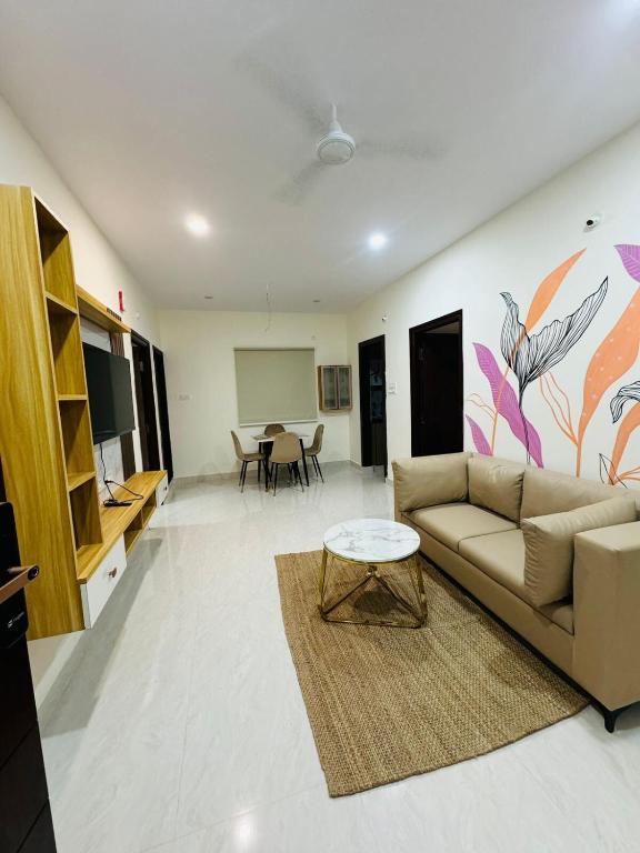 a living room with a couch and a table at Your Homely Stay in kondapur in Kondapur