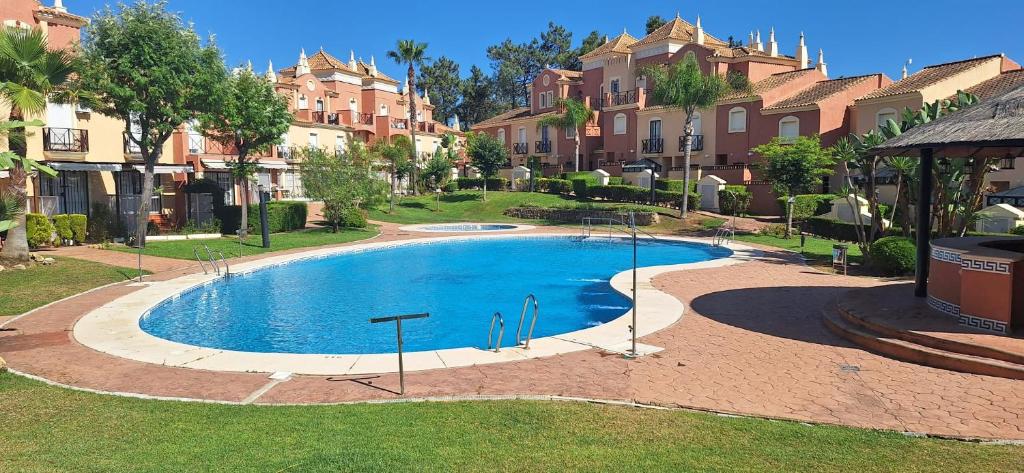 a swimming pool in a residential neighborhood with houses at Casa Ani in Huelva