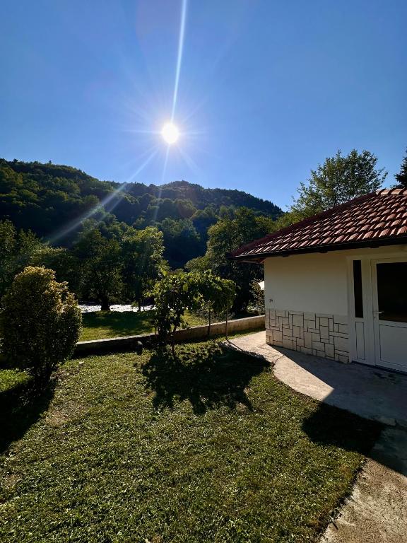 a house with a view of a mountain at Oaza Vrbas - Riverside Bungalow in Jajce