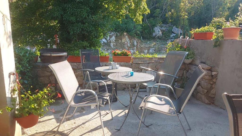 a table and chairs sitting on a patio at Apartment Di Novi Vinodolski in Novi Vinodolski