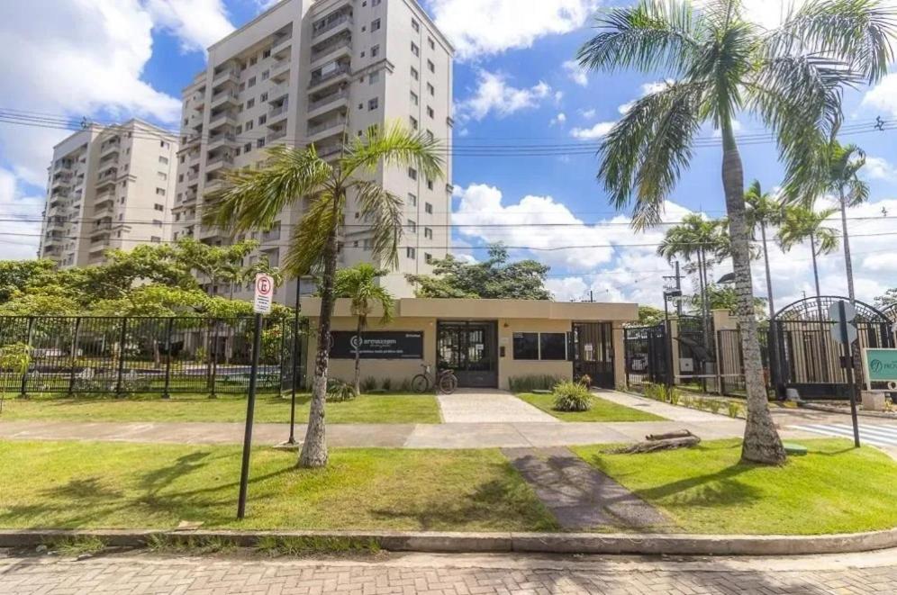 a building with palm trees in front of it at COP 30 Apartamento Luxo - 3 Quartos, Piscina, Academia, Area de Lazer in Belém