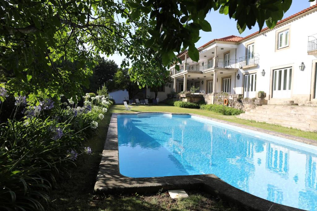 a swimming pool in front of a house at Swimming Pool Bedroom at Casa dos Macieis, Camino Santiago direct access & Optional Agritourism in Facha